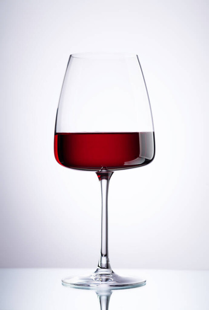 Copa de vino tinto sobre fondo gris - Foto, imagen