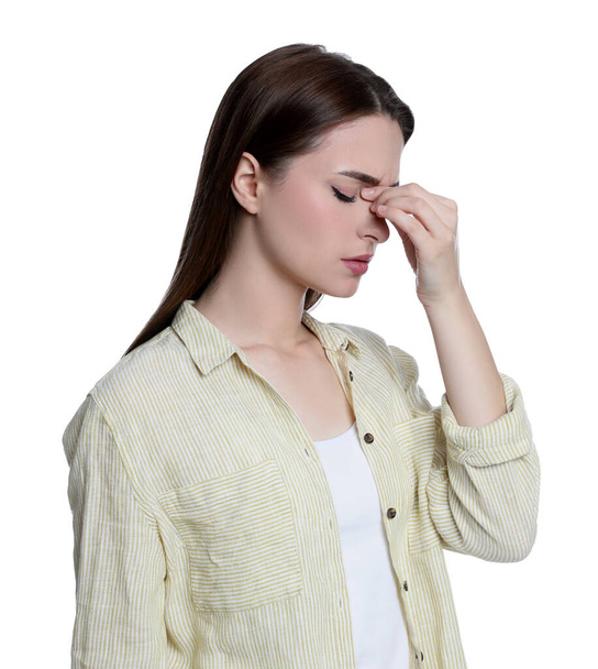 Young woman suffering from headache on white background - Foto, afbeelding