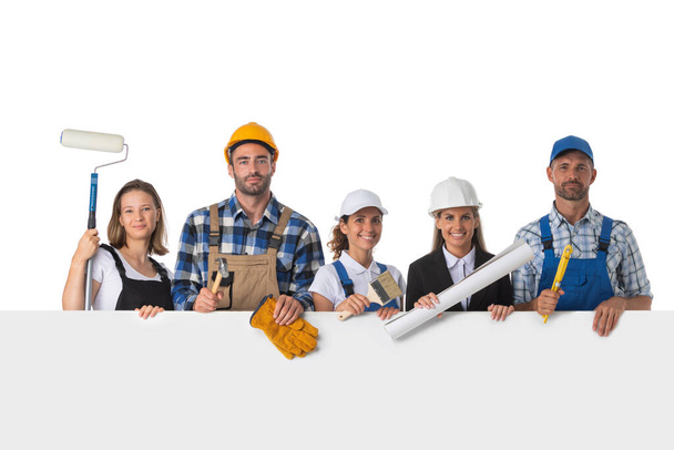 Group of industrial workers with blank banner isolated over white background - Fotoğraf, Görsel