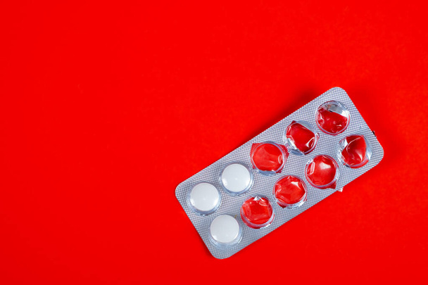 Pills Pack on the Red Paper Background closeup - Fotó, kép