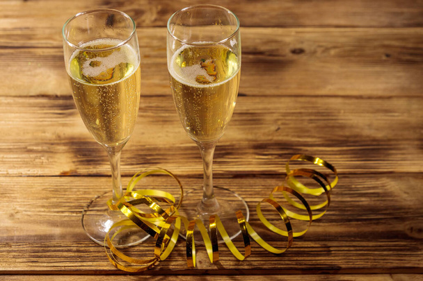 Twee glazen champagne op houten tafel - Foto, afbeelding