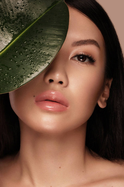 Beautiful delicate woman of oriental type with nude makeup and perfect skin. Beauty face. Spa - Фото, зображення