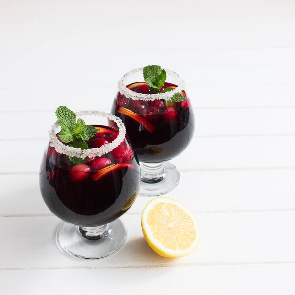 Alcohol cranberry lemon wine peppermint festive cocktail square. - Foto, imagen