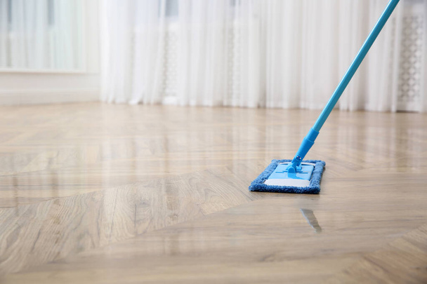 Washing of parquet floor with mop indoors, closeup. Space for text - Fotó, kép