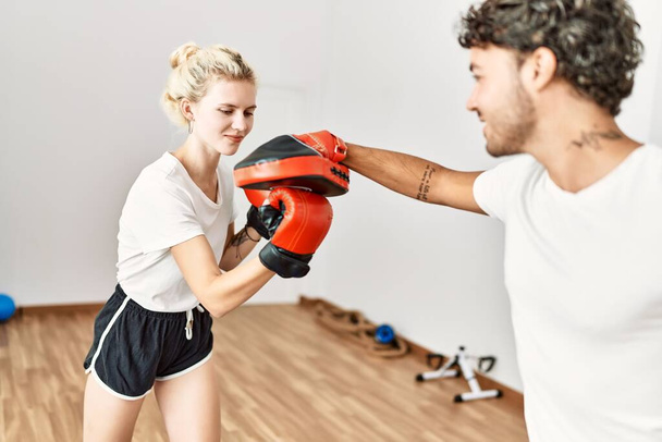 Young couple training boxing at sport center. - Фото, изображение