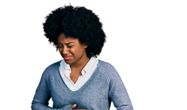 Young african american woman wearing business clothes with hand on stomach because indigestion, painful illness feeling unwell. ache concept.  - Zdjęcie, obraz