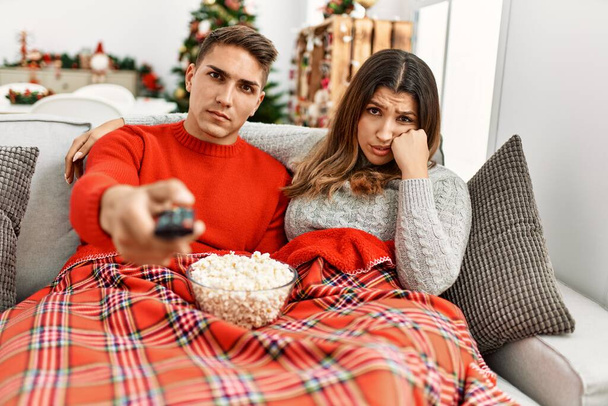Young couple watching movie and eating popcorn at home. - Valokuva, kuva