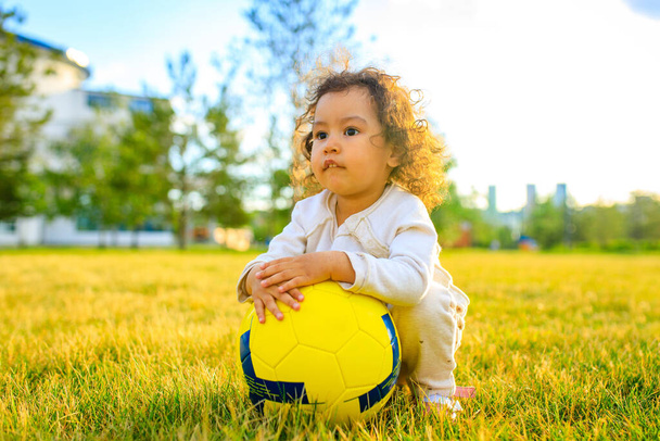 afro american little girl with curly hair playing ball outdoors - Photo, Image