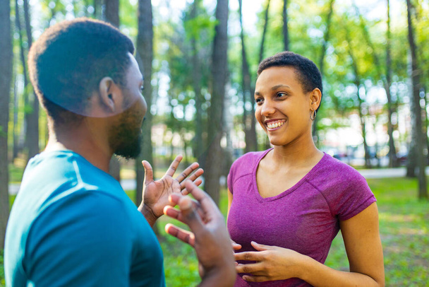 african american couple talking together in summer park - Foto, afbeelding