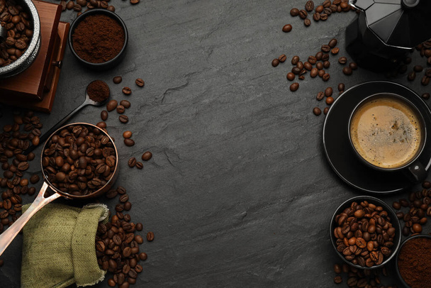 Flat lay composition with coffee grounds and roasted beans on black background, space for text - 写真・画像