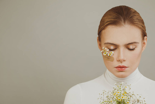 Gentle young woman with flowers, hope concept - Foto, imagen