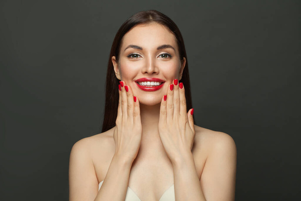 Healthy model woman showing red manicured nails - 写真・画像