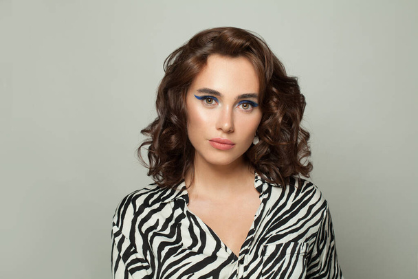 Attraente modello di moda donna con acconciatura riccia marrone su sfondo bianco - Foto, immagini