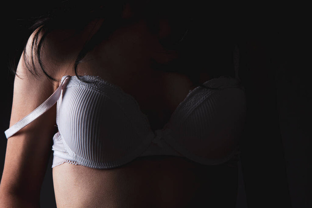 young woman stands in bras - 写真・画像
