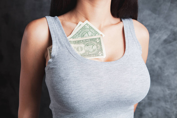 woman holding money at her chest - Foto, imagen