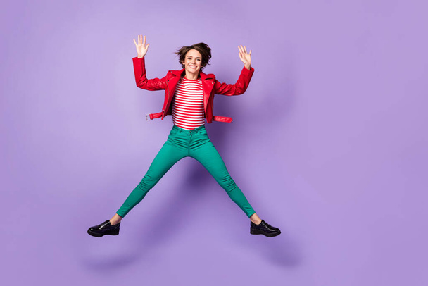 Full length photo of young cheerful girl happy positive smile have fun jump wave hello isolated over purple color background - Φωτογραφία, εικόνα