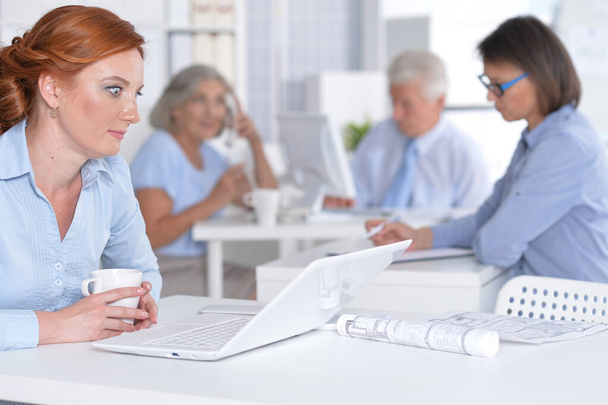  business  woman working in office  with colleagues on background - Photo, Image