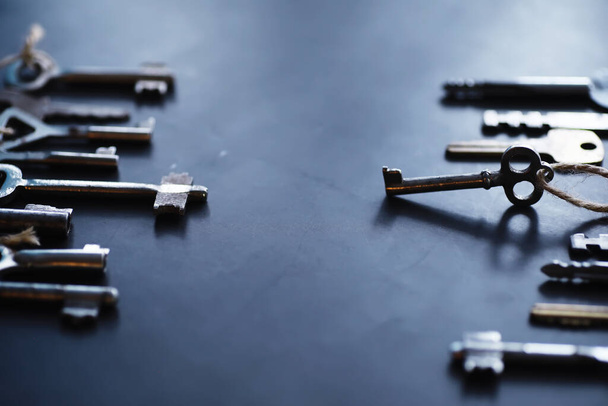 Set of vintage keys for lock. Retro keys on a dark stone background. The concept of choosing the path to achieve the goal. - Photo, Image