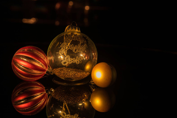 Christmas decoration with tree balls balls reflected in a mirror and lights with effect bokeh in the background - Photo, Image