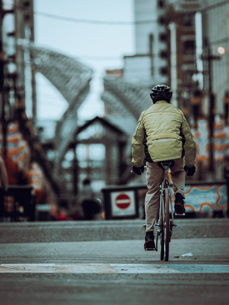 CALGARY, CANADA - Oct 24, 2021: A man riding his bike on a gloomy day in Calgary downtown in Alberta - 写真・画像