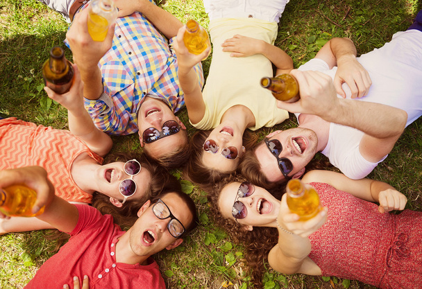 People lying on the grass with drinks - Foto, Imagem