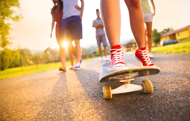 Legs of young people on skateboard - Fotoğraf, Görsel