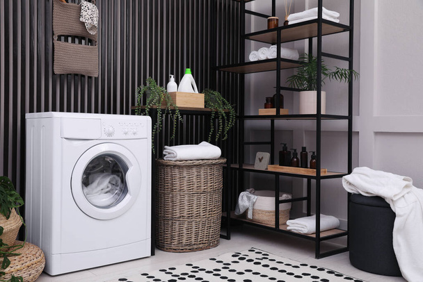 Laundry room interior with washing machine and stylish furniture - Фото, изображение