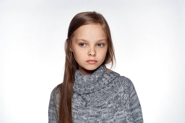 girl in sweater temperature health problems light background - Фото, зображення
