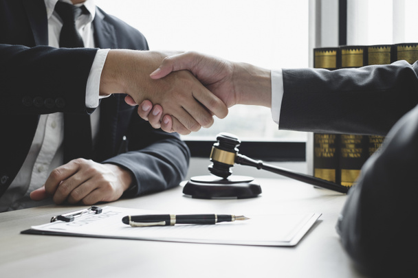 shake hand Professional man lawyers work at a law office There are scales, Scales of justice, judges gavel, and litigation documents. Concepts of law and justice. - Photo, Image