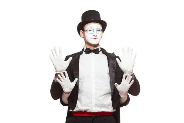 Portrait of two mime artists performing, isolated on white background. Mime hid behind his friend, standing with their hands raised. - Photo, image