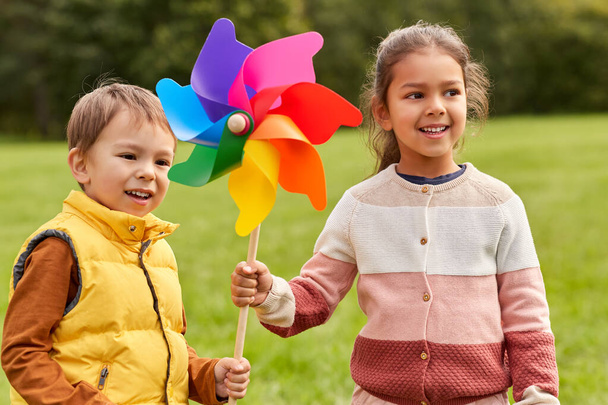 happy kids with pinwheel having fun at park - Photo, image