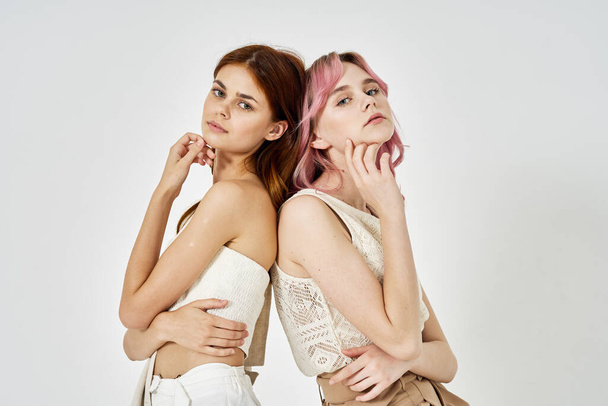 two girlfriends stand side by side fashion clothing glamor posing - Фото, зображення
