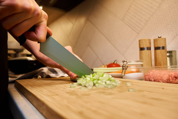 Woman cuts celery slices - Foto, immagini