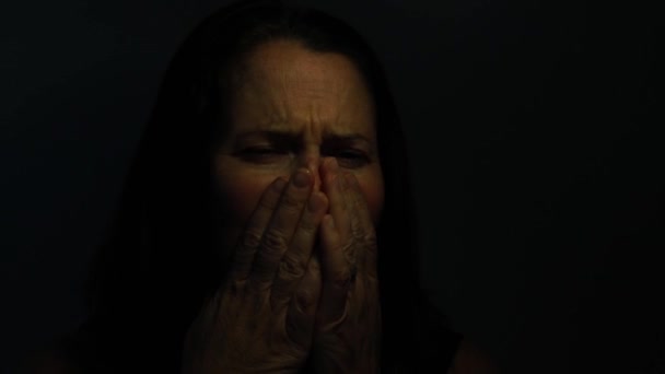 Upset woman emerging from the dark - Footage, Video