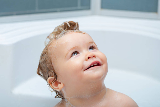 Child bathing. Little baby taking bath, closeup face portrait of smiling boy, health care and kids hygiene. Funny kids face close up. - Photo, image