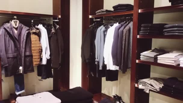 Clothing retail and sustainable fashion concept. Assortment of luxury menswear, autumn and winter collection in mass market brand store - Footage, Video