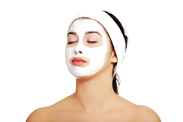 Relaxed woman with a nourishing face mask - Фото, зображення