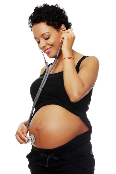 Pregnant  woman with stethoscope listening to baby - Zdjęcie, obraz