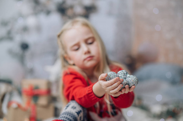 Portrait of little girl holding christmas ball or ornament - Fotografie, Obrázek