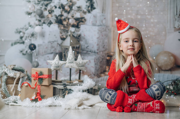 Красива блондинка в різдвяному капелюсі і червоному светрі. Різдвяні вітальні листівки дизайн
 - Фото, зображення