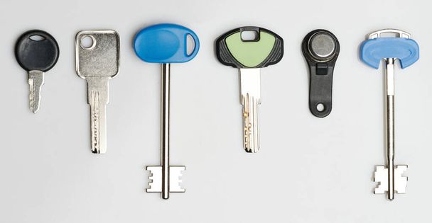 Different metal keys for doors isolated on studio background - Photo, Image