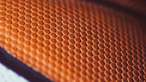 Close-up shot of a standard sized basketball's surface texture. - Фото, изображение