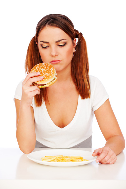 Traurige Frau mit Burger und Kartoffeln - Foto, Bild