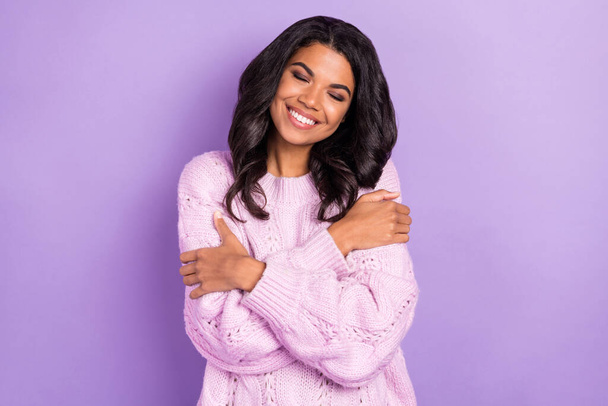 Photo of adorable sweet dark skin lady dressed knitted pullover hugging herself closed eyes isolated purple color background - Fotoğraf, Görsel