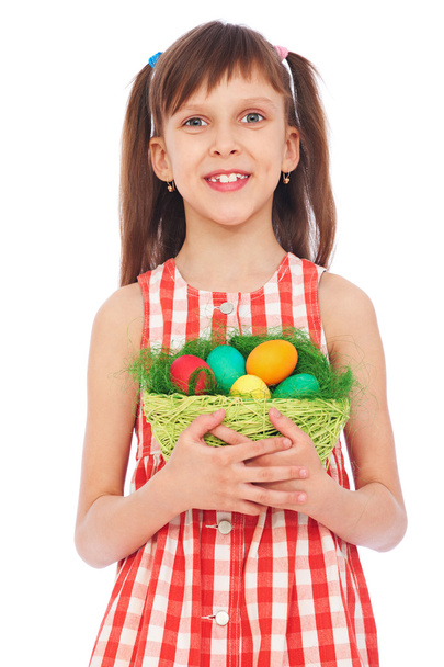 Smiley girl holding basket with colorful eggs - Fotoğraf, Görsel