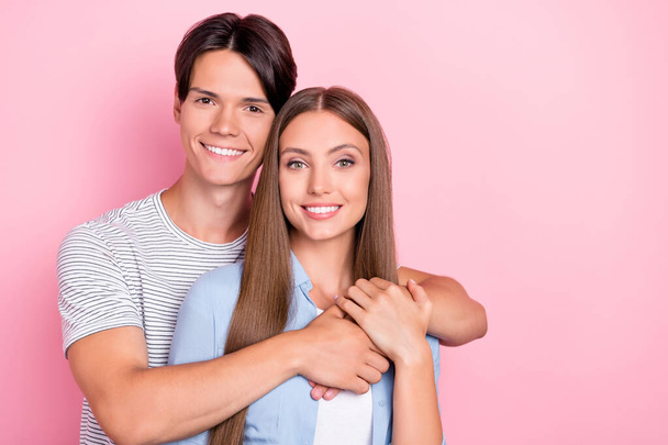 Photo of adorable shiny young lovers dressed casual outfits embracing smiling isolated pink color background - Photo, Image