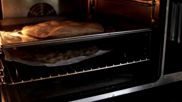 Pizza baked in microwave oven at home kitchen - Footage, Video