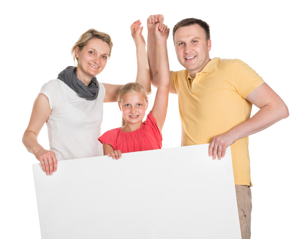 Happy Young Family Holding Banner - Foto, afbeelding
