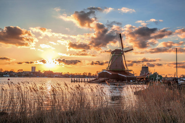 Molinos tradicionales holandeses contra el colorido atardecer en Zaanse Schans, zona de Ámsterdam, Holanda - Foto, imagen