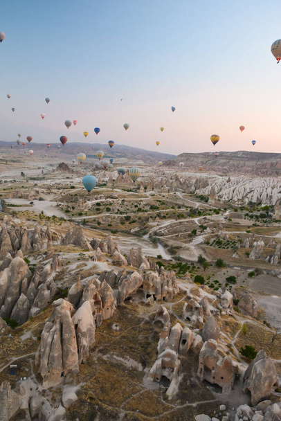 Amazing balloons soaring at sunrise among the bizarre mountains of Cappadocia - Foto, immagini